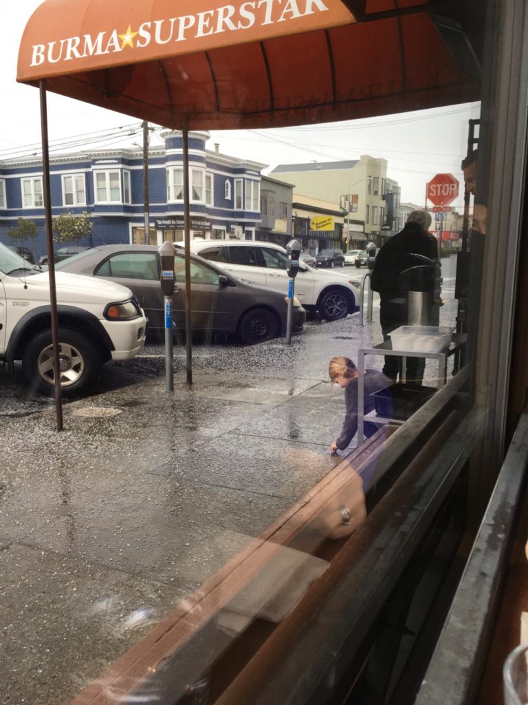 little girl picking up hail in San Francisco