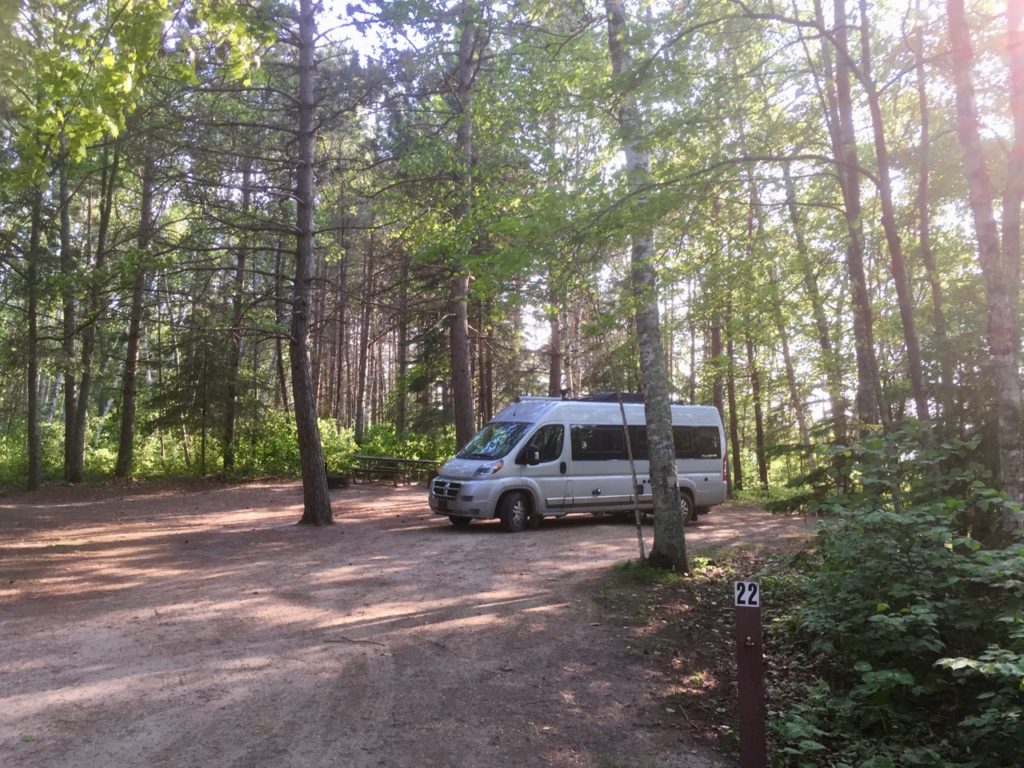 Van surrounded by trees