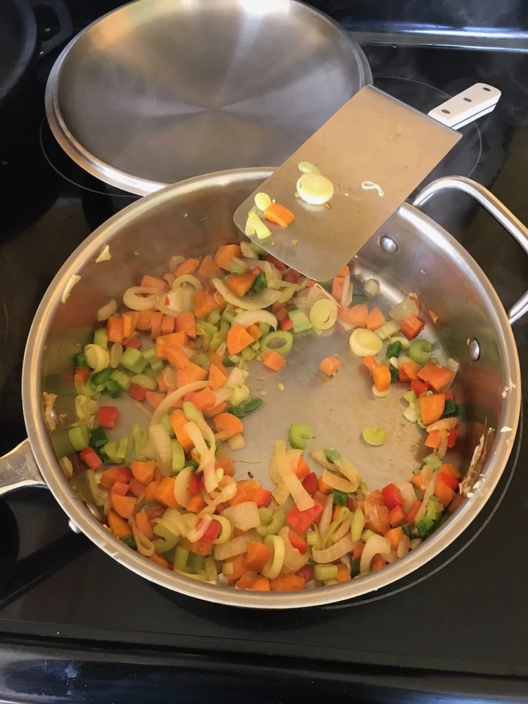 a big pan of chopped vegetables cooking