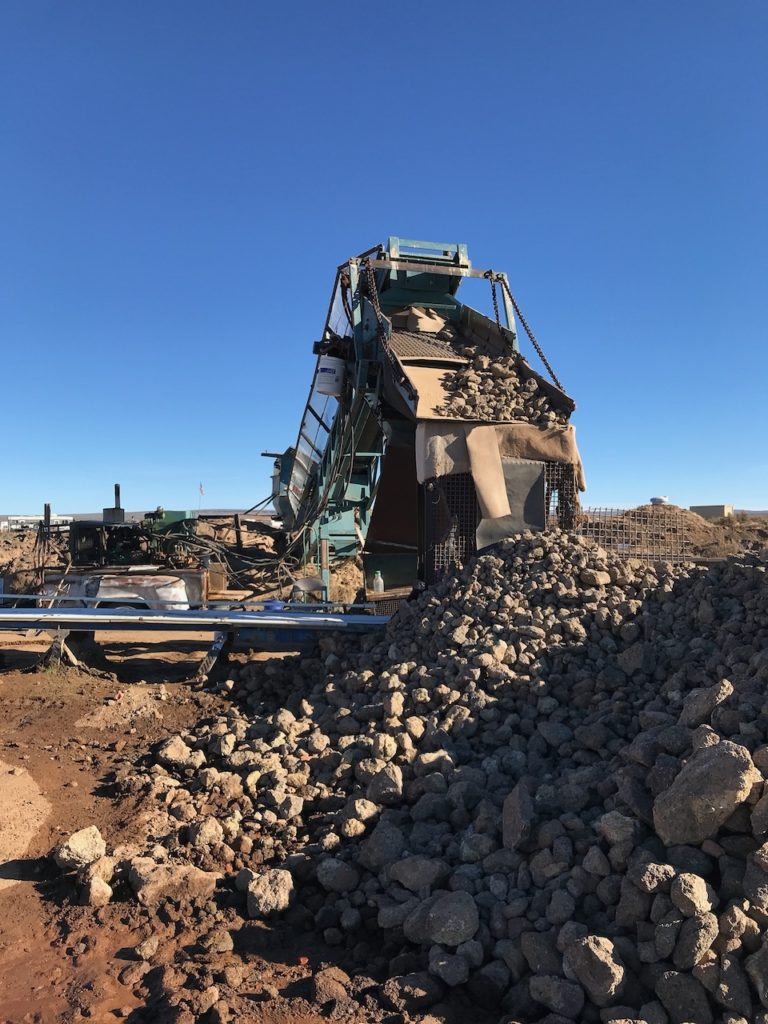 pile of rubble with a conveyor belt machine. 