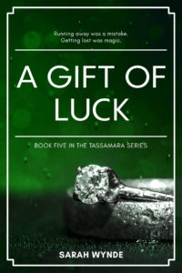 Book cover for A Gift of Luck with a mask on part of the ring