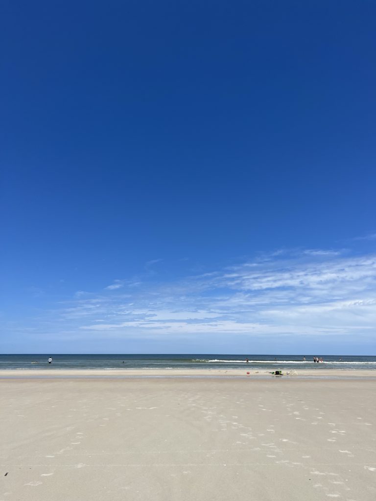 pristine blue sky and light sand beach